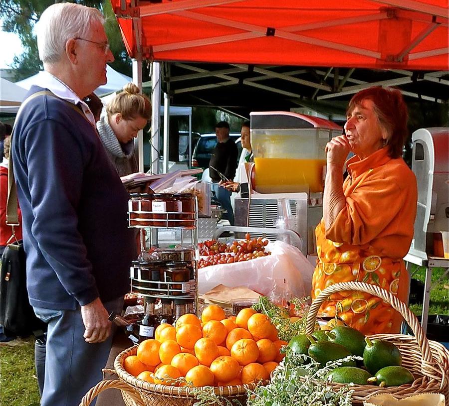 The Orange Lady, Gaby Robb, selling citrus, grapes and avocados at a local farmers market, grown on their family farm.