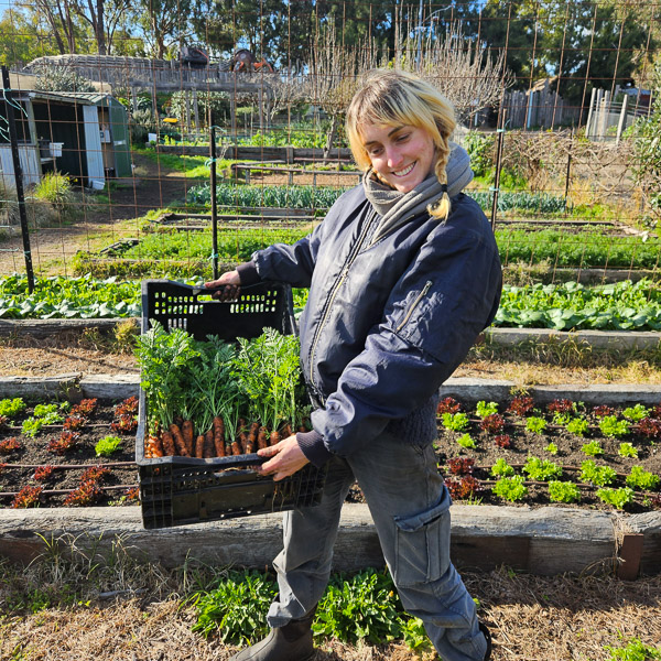 Lucille with freshly harvested carrots at Honey Lane, CERES Brunswick